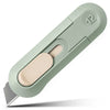 A light green compact mini paper cutter with a beige blade and a numbered box opener feature.