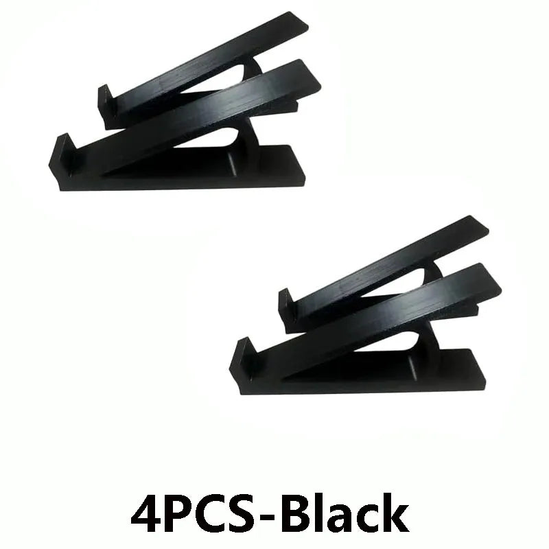 Four black adjustable keyboard tray riser pieces.