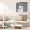 A silver tablet holder with a flexible white gooseneck arm is shown next to a sofa.