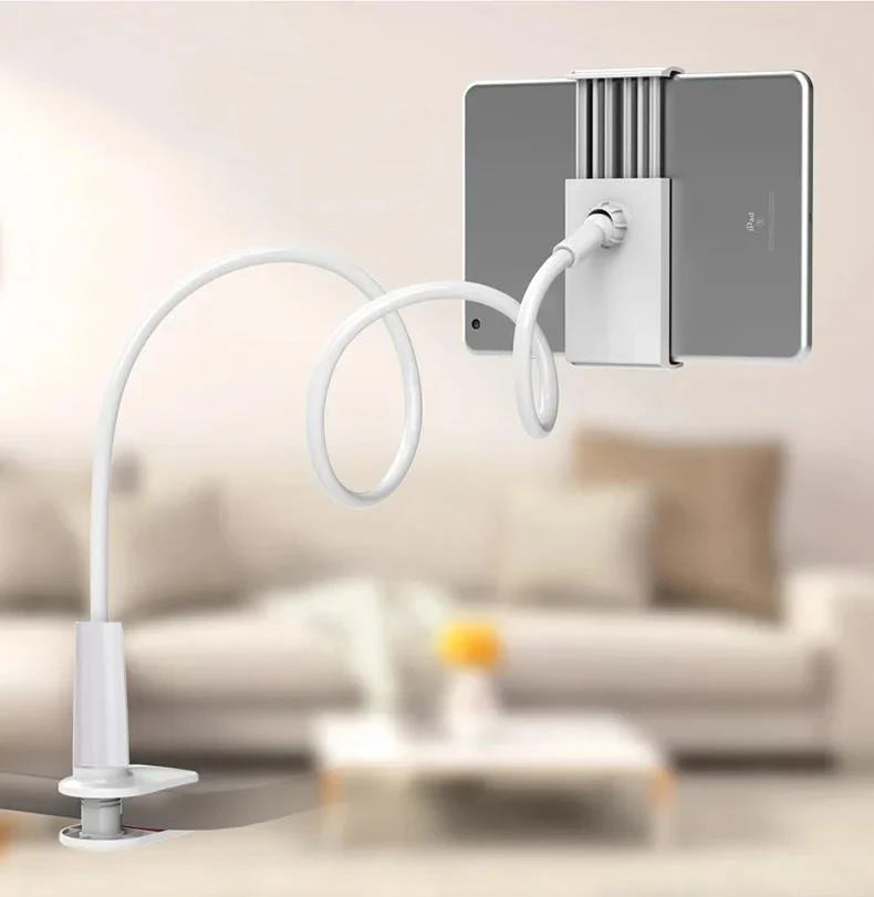 A silver tablet holder with a flexible white gooseneck arm is shown next to a sofa.