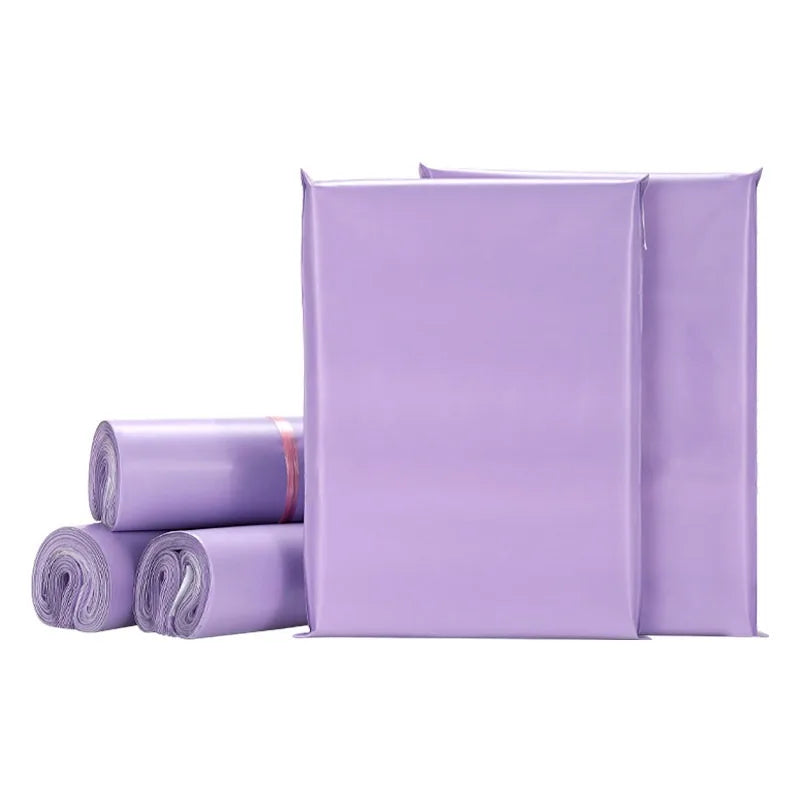 A stack of matte purple self-adhesive mailing bags in various sizes.