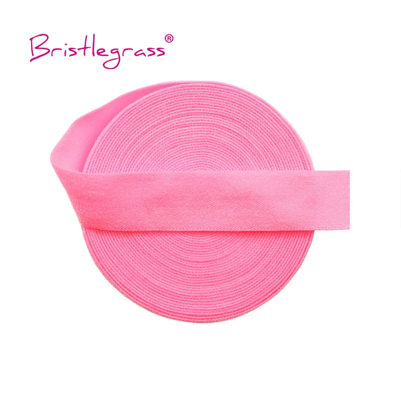 Pink bristleglass elastic hair ties and trims rolled into a flat, circular shape
