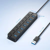 A black 7-port USB 3.0 hub extender with a long cable is shown against a light blue background.