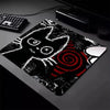 A black cat design mouse pad with a non-slip rubber base is shown on a dark surface.