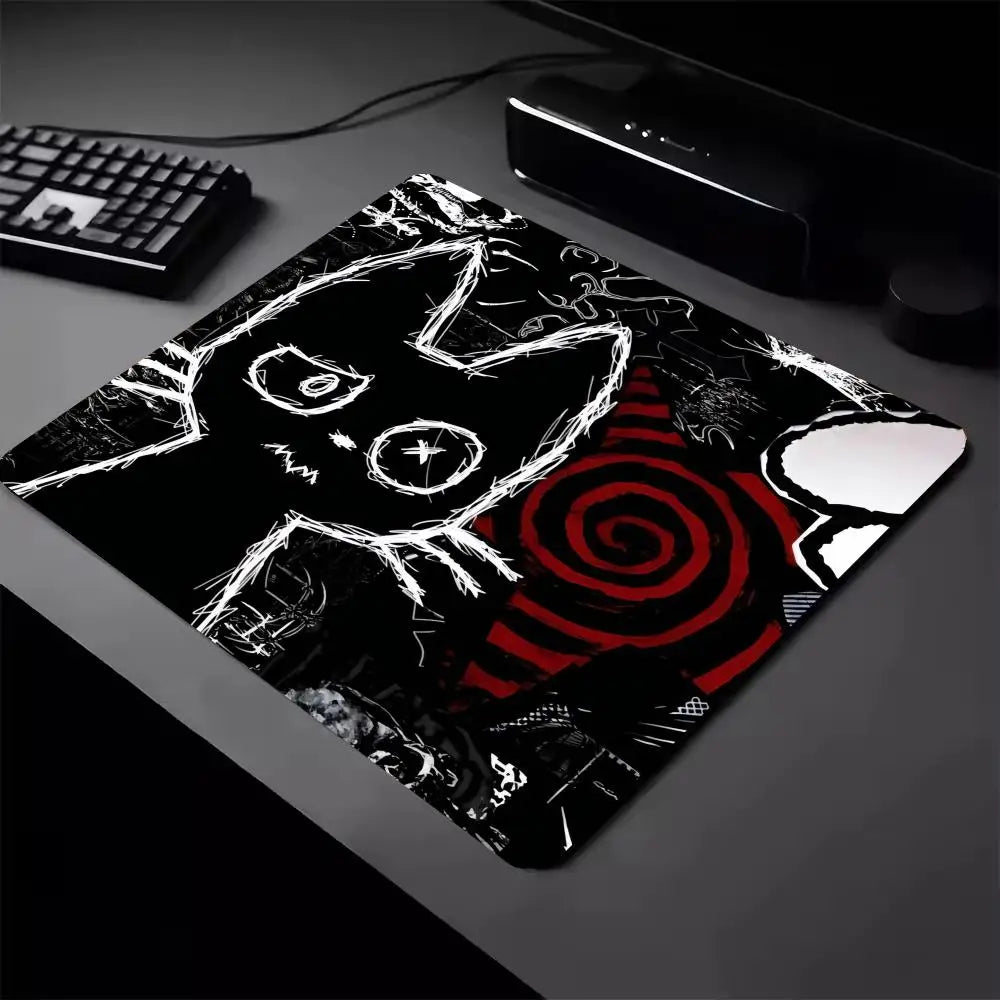 A black cat design mouse pad with a non-slip rubber base is shown on a dark surface.