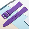A purple silicone watch strap is shown next to its replacement tools on a light background.