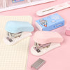 A set of cartoon mini staplers in light blue and pink, displayed on a pink background with stationery.