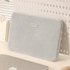A light gray padded laptop sleeve is displayed against a white background.