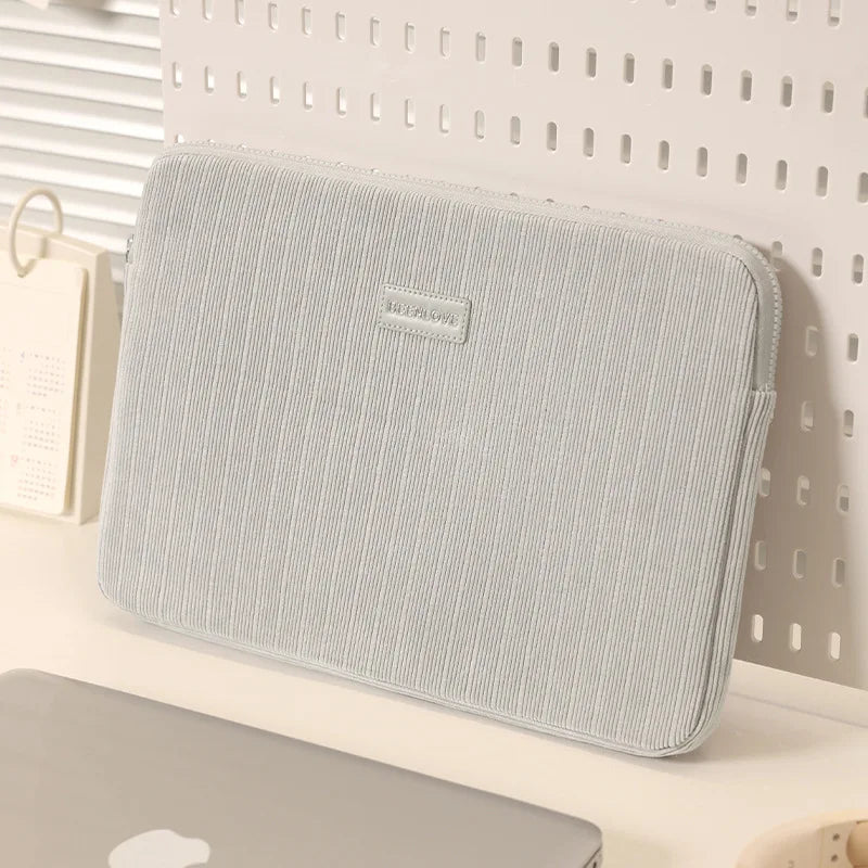 A light gray padded laptop sleeve is displayed against a white background.