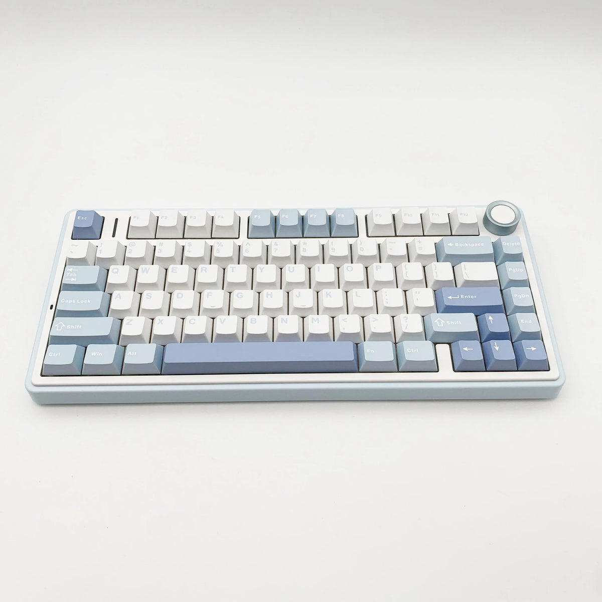 A light blue mechanical gaming keyboard with a full layout and customizable keycaps is shown on a white background.