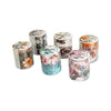 A collection of decorative washi tape rolls featuring floral patterns and natural textures.