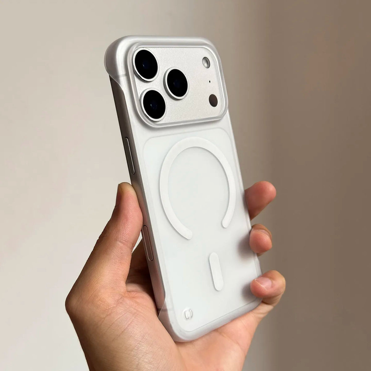 A hand holds a white Slim Magnetic Phone Case for iPhone Magsafe, showing the back design.