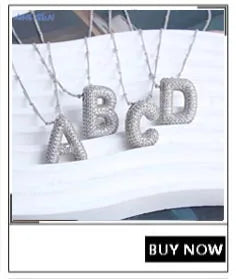 A set of gold-plated shell pearl beaded necklaces spelling out the letters A through D.