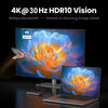 A laptop is shown next to a monitor displaying a vibrant 4K HDR10 vision image of a flower.
