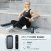 A woman sits on steps using a portable solar power bank for charging.