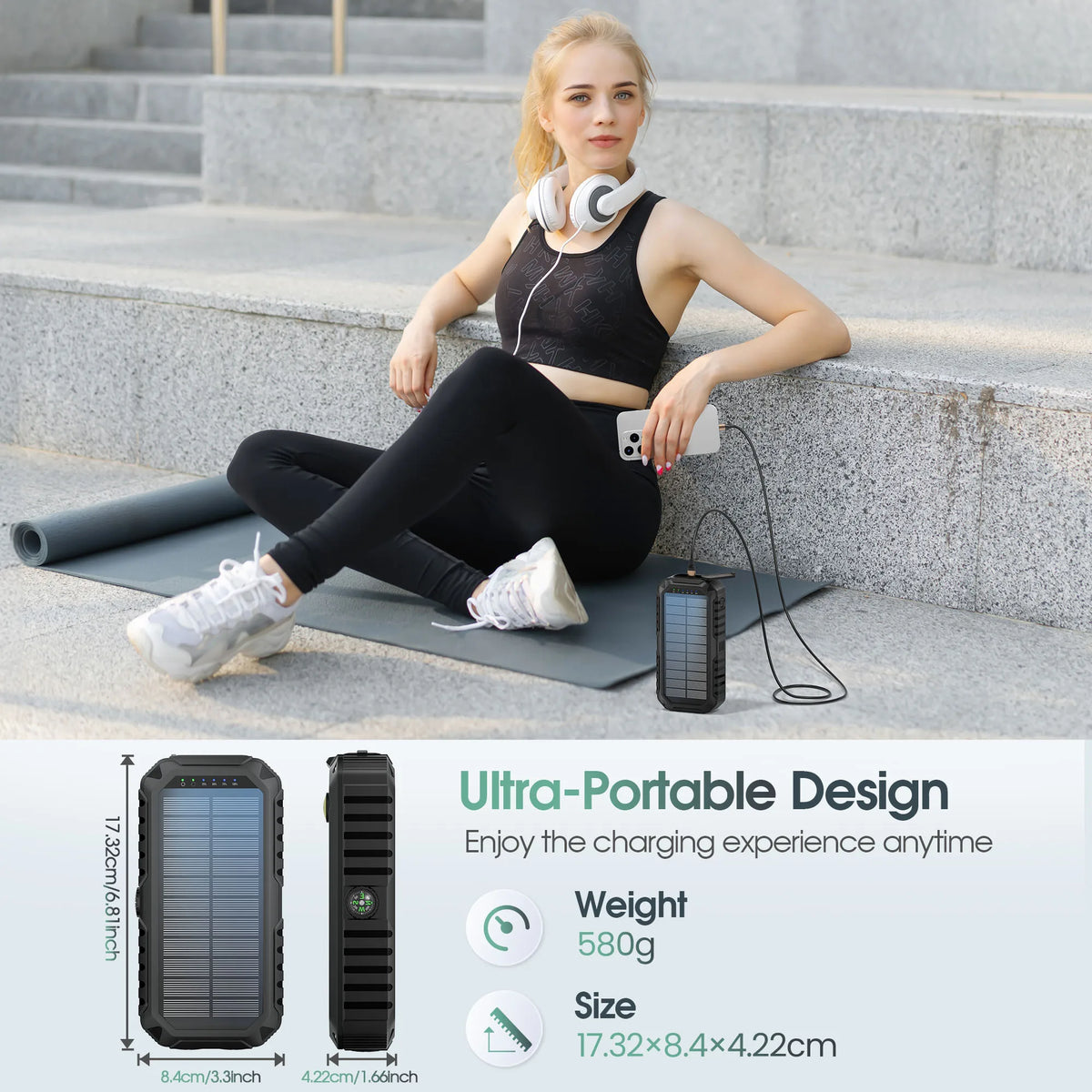 A woman sits on steps using a portable solar power bank for charging.