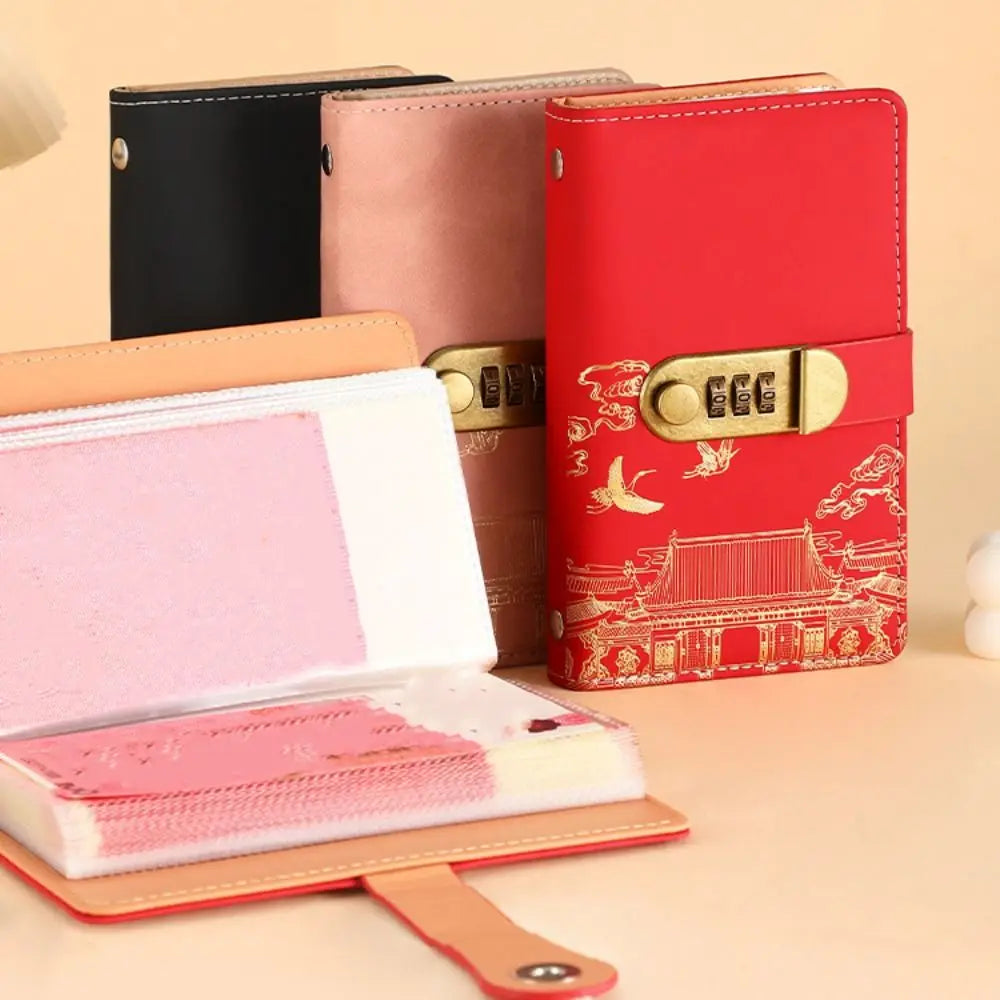 A set of personal finance budget binders in black, pink, and red with gold accents.