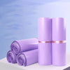 Rolls of purple waterproof self-adhesive courier mailer bags displayed on a white surface.