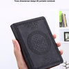 A hand holds a black retro PU leather pocket notebook with an embossed design.