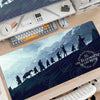A large gaming mouse pad featuring a dark landscape with figures from Lord of the Rings and circular designs.