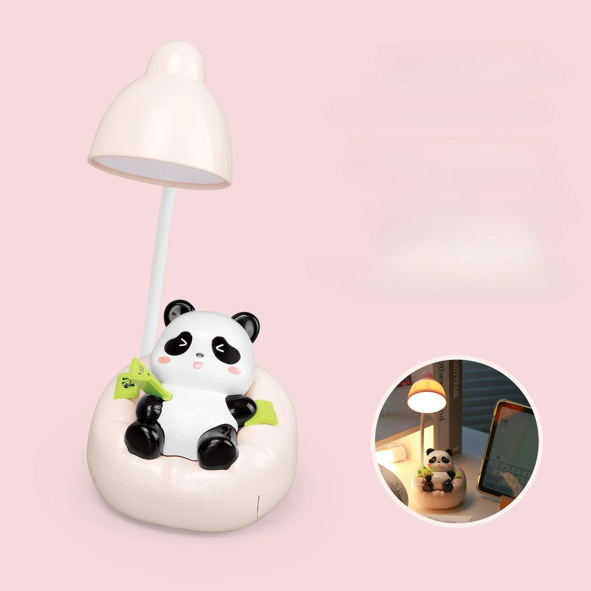 A white panda-shaped LED desk lamp with a flexible arm and a mobile phone holder on a pink background.