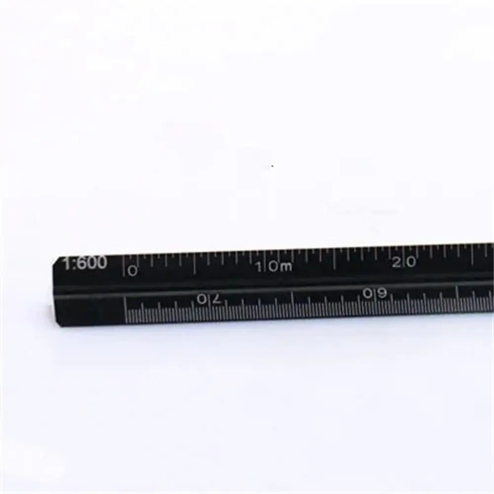 A close-up photo of a black aluminum triangular scale ruler showing markings up to 20 centimeters.