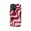 A phone case featuring a dual-layer design with swirling pink and maroon patterns.