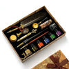 A luxury fountain pen set with a wax seal kit displayed in a wooden box.