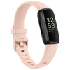 A pink silicone replacement strap for a Fitbit Inspire series watch with a black band and digital display.