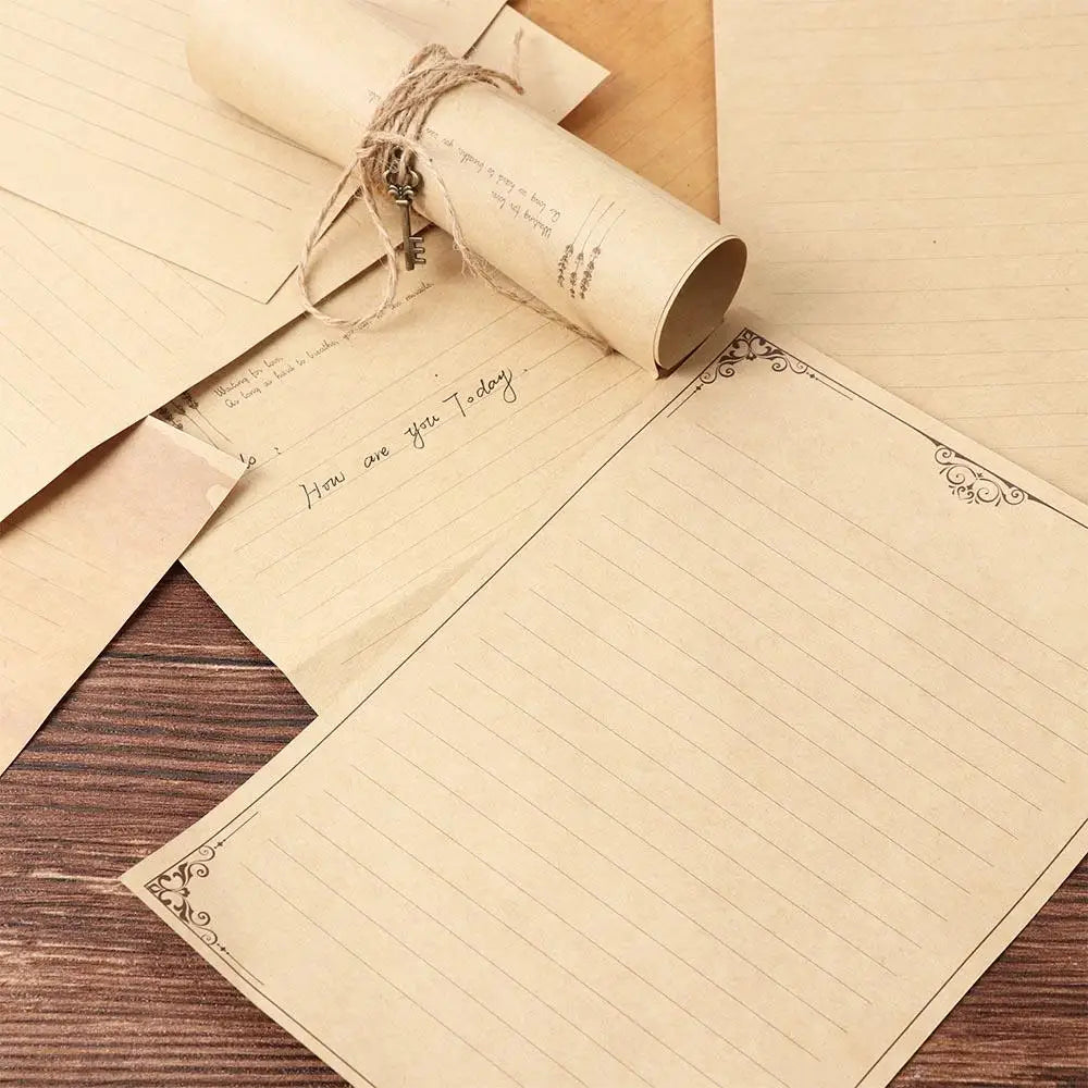 A set of vintage European style letter and invitation envelopes lying on a wooden surface.