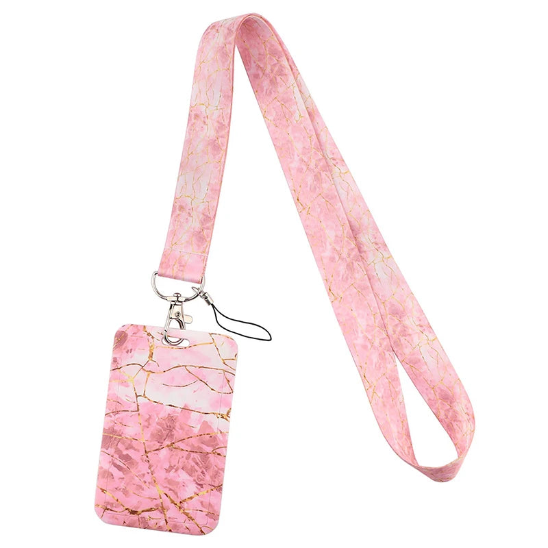 Pink marbled ribbon lanyard with a gold-toned clasp and a square tag.