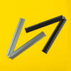 A set of three precision aluminum folding rulers laid diagonally on a bright yellow background.