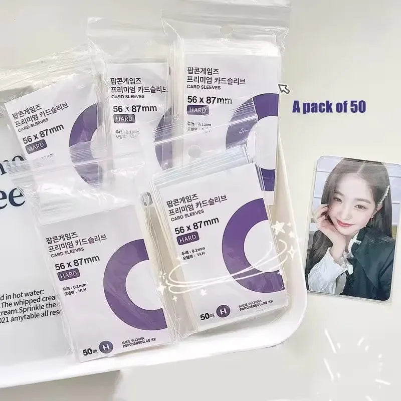 A pack of 50 transparent protective card sleeves in purple and white packaging.