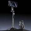 A black magnetic selfie stick with a smartphone attached is displayed on a stand.
