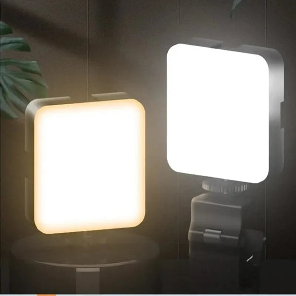 A close-up view of a mini clip-on LED fill light with a square white light panel mounted on a gray base.