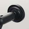 A close-up view of a black magnetic phone and tablet stand with a circular gripping mechanism.