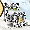 A white and black cow print photo card binder with a heart-shaped clear window displaying a photo.