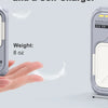 A hand holds a silver magnetic wireless power bank with built-in cables and a foldable plug, showing its dimensions.