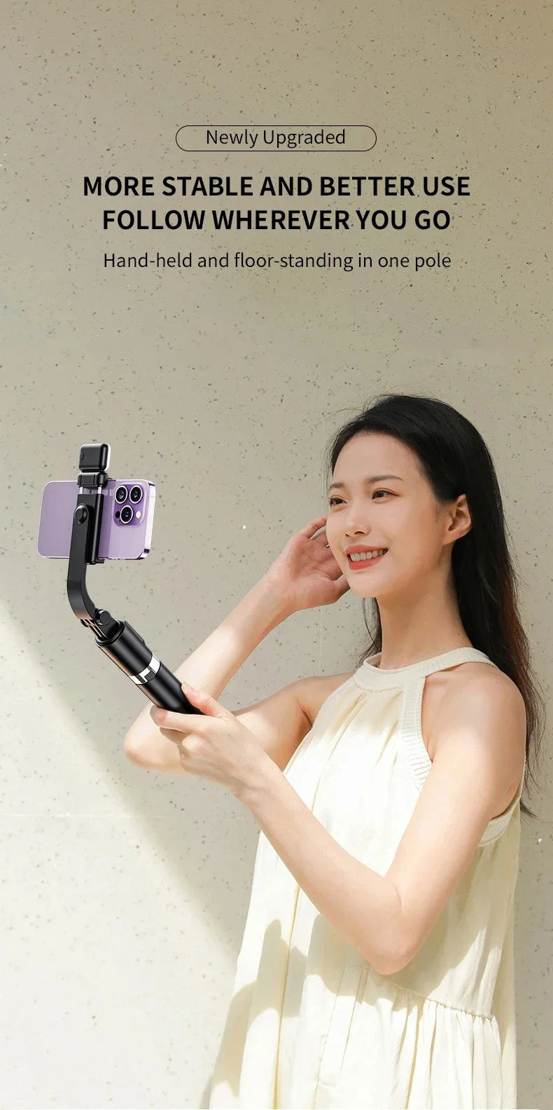 A woman holds an ultra-long selfie stick with a smartphone and Bluetooth remote in her hand.