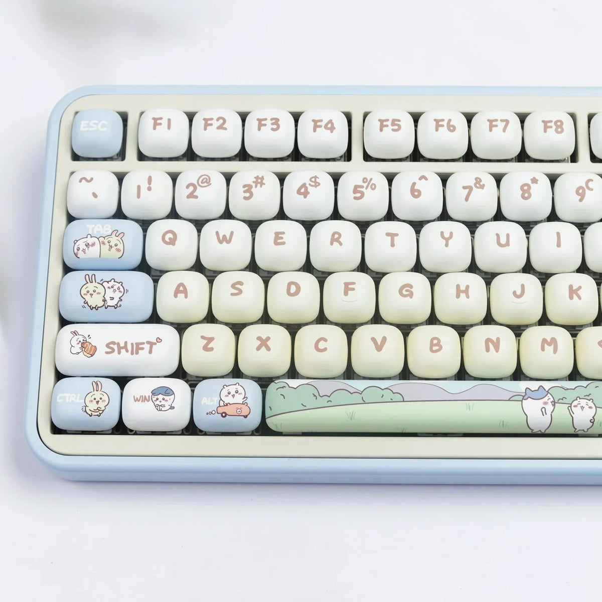 A close-up view of a light blue mechanical keyboard featuring custom dye-sublimated PBT keycaps with cute animal designs.