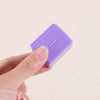 A hand holds a purple privacy protection roller stamp for confidential documents.