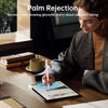 A woman is using a pink stylus on an iPad, demonstrating palm rejection technology.