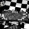 A close-up of a black mechanical keyboard featuring a comic-style PBT keycap set with black and white themes.