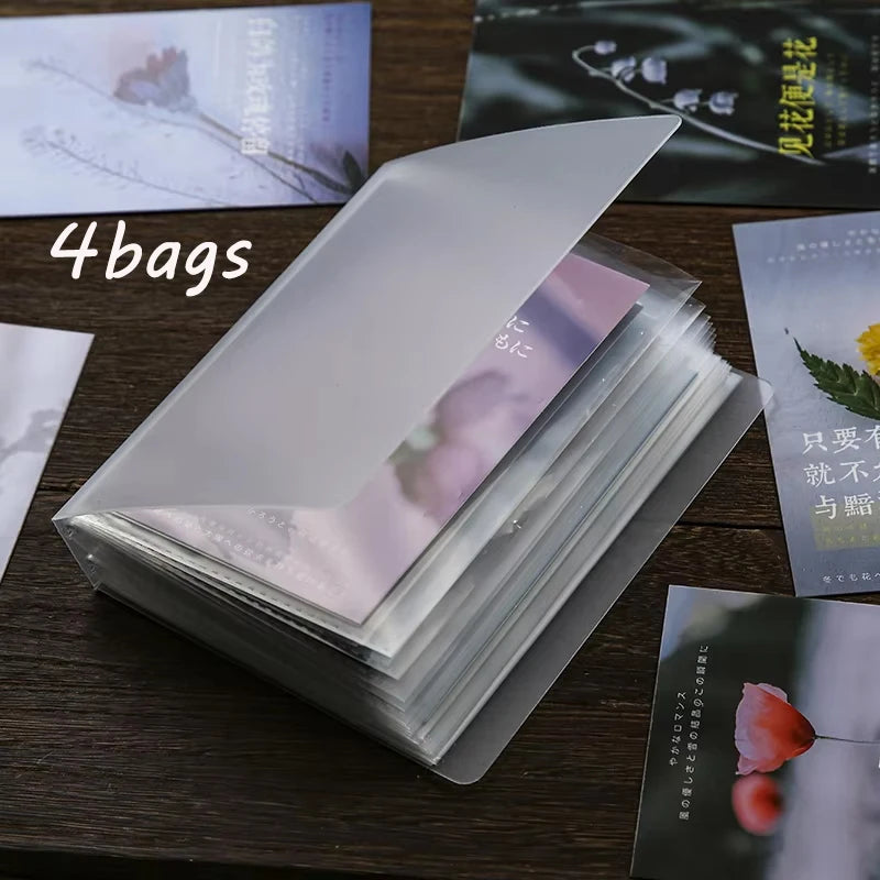 A stack of four A6 photo storage booklets is displayed on a wooden surface.