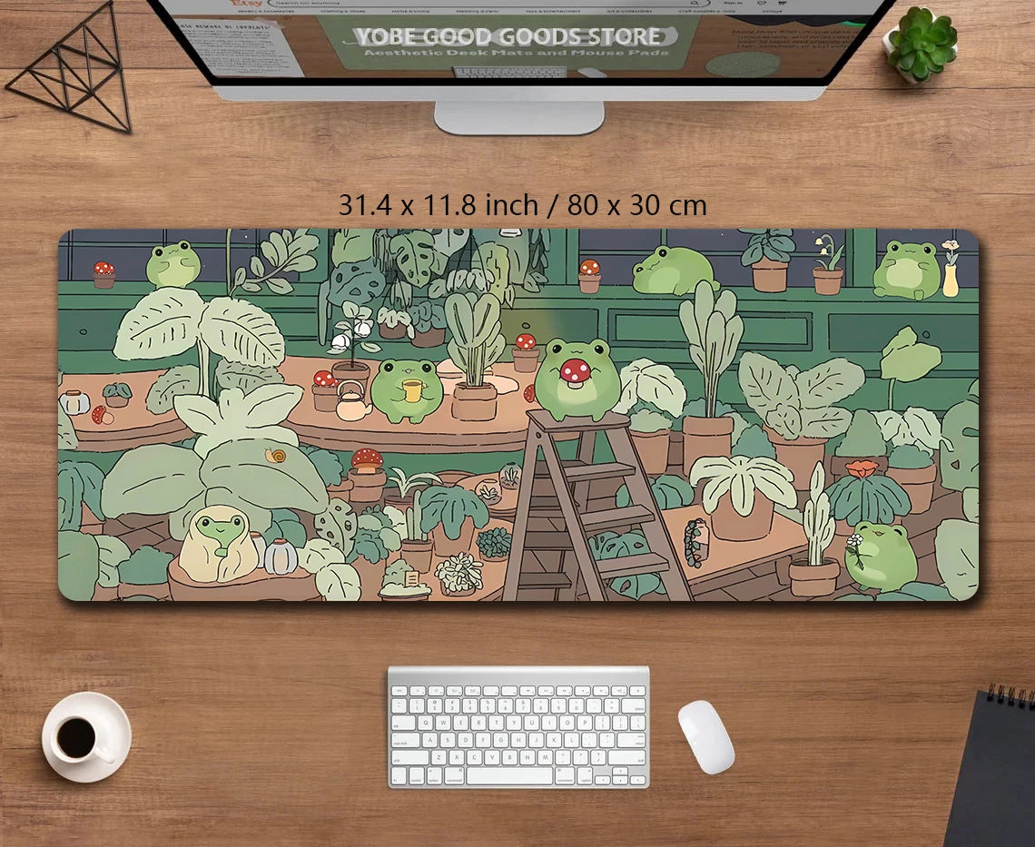 A large green kawaii frog desk mat featuring various potted plants and natural elements.