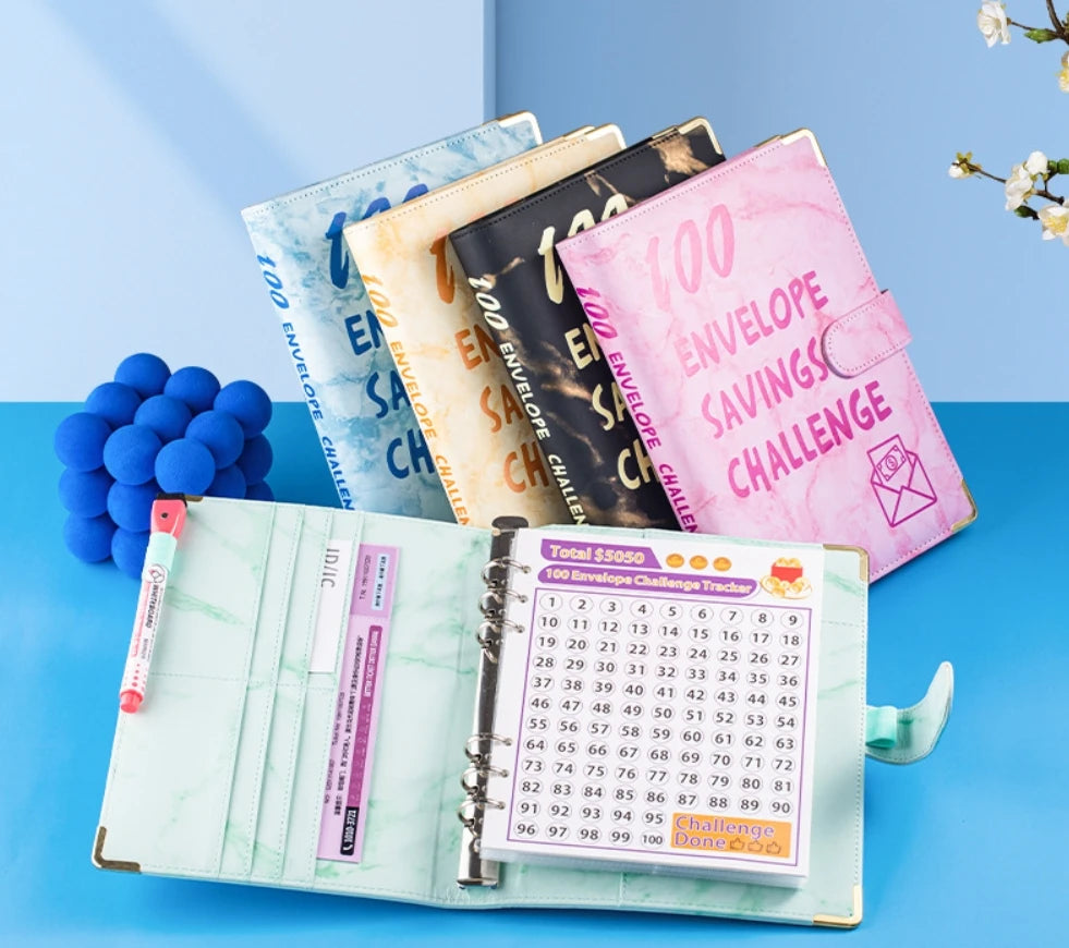 A5 marble budget binder with cash envelopes and a numbered challenge tracker.