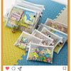 A set of clear reusable zipper mesh storage bags filled with colorful toys and craft items on a blue textured surface.