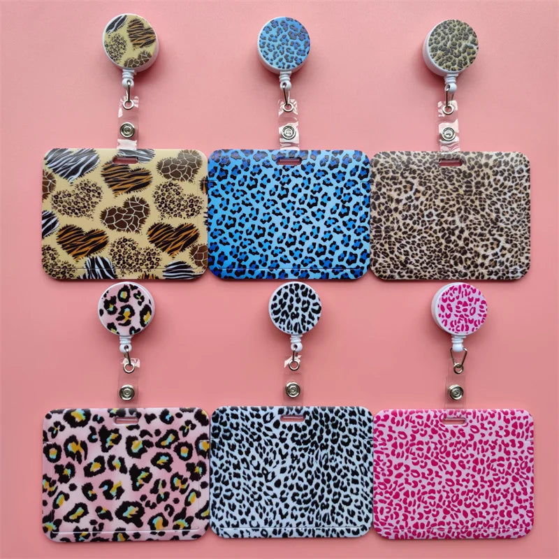 A collection of leopard print retractable card holder clips in various colors and patterns.