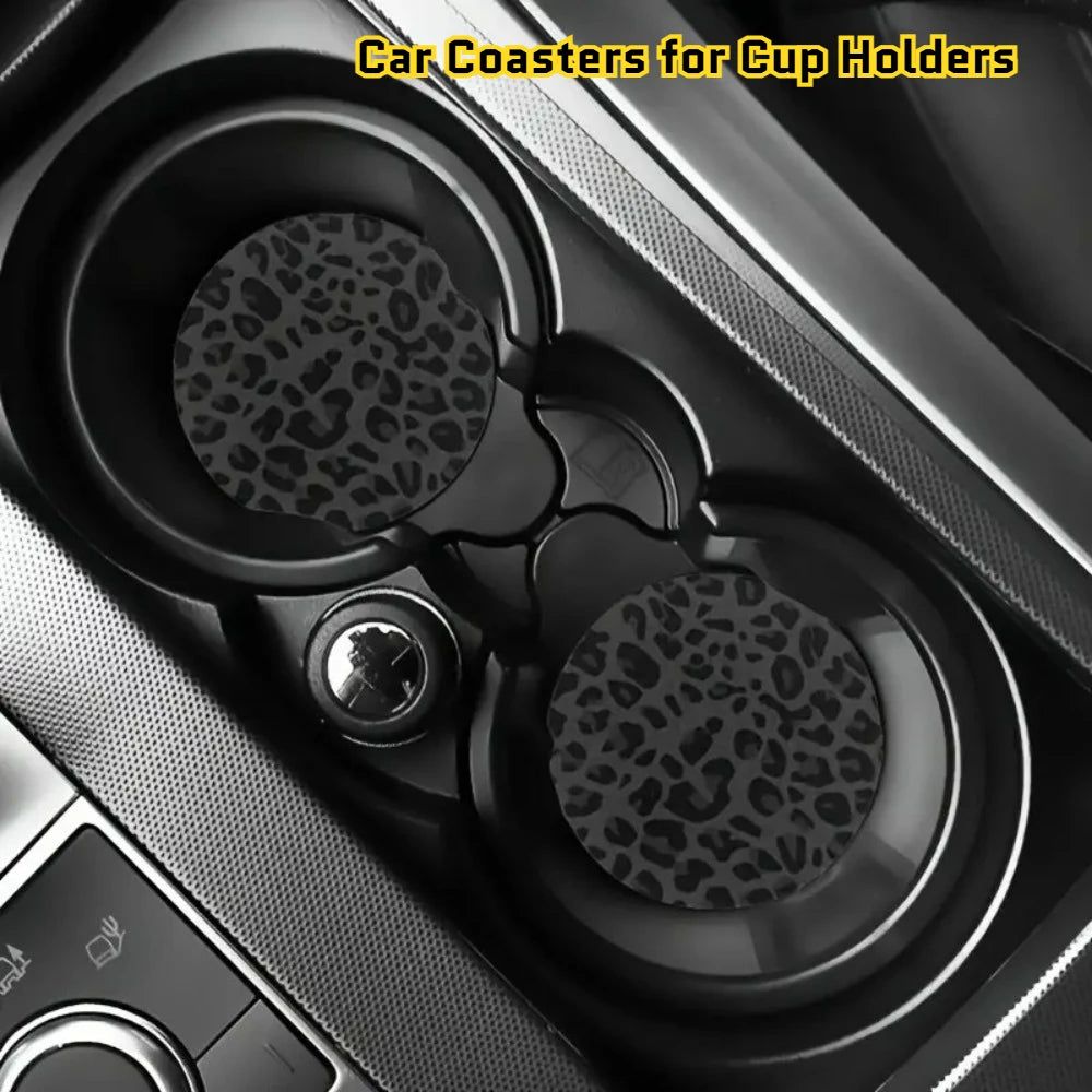 Two non-slip leather coasters with leopard print designs placed in a car cup holder.
