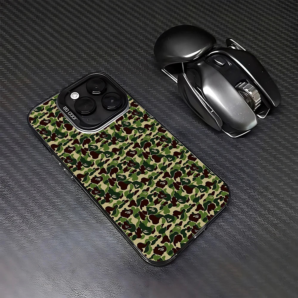 A camouflage patterned phone case for an iPhone next to a black wireless mouse.